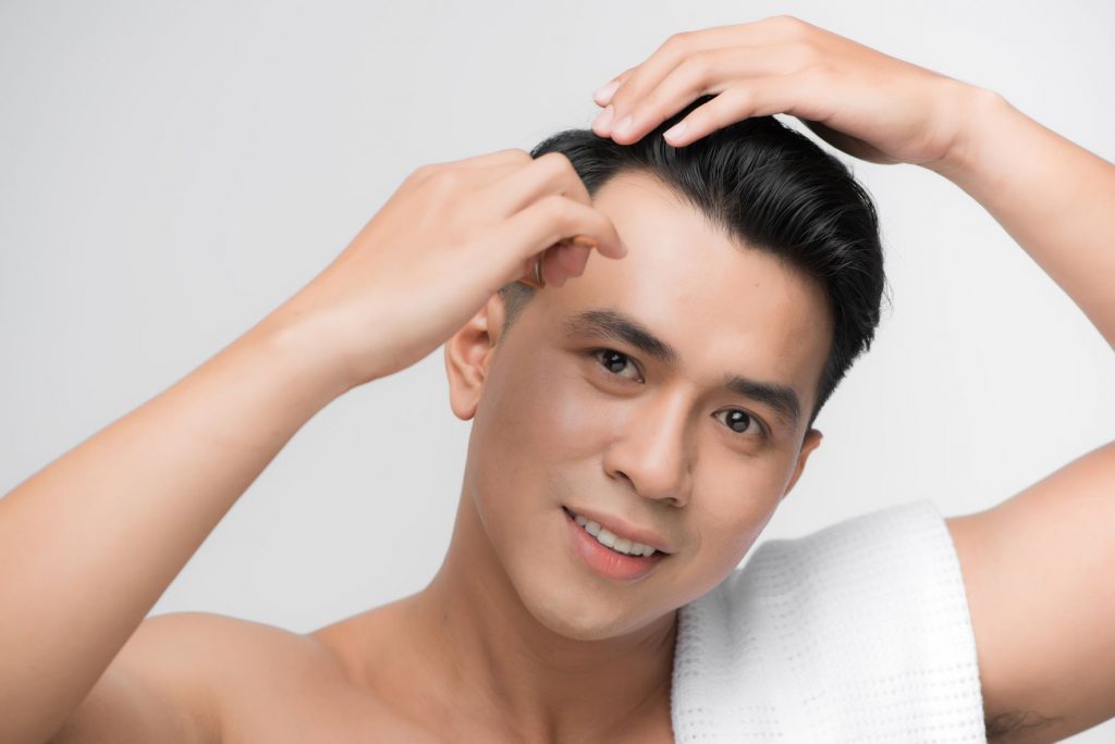 Asian man with a comb over hairstyle