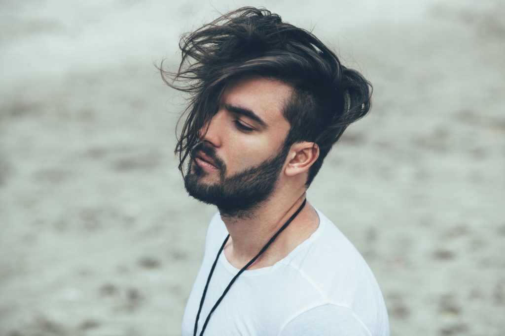 man with a fauxhawk and a bread