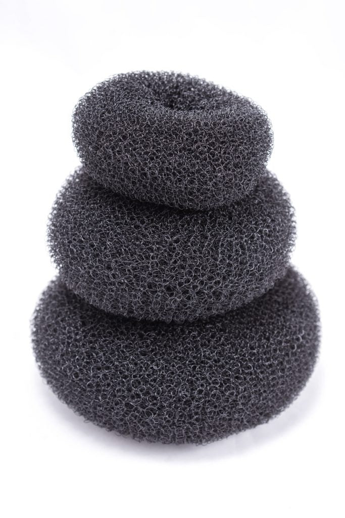 Avoid hair damage with heatless curl tools like these three gray, mesh hair donuts.