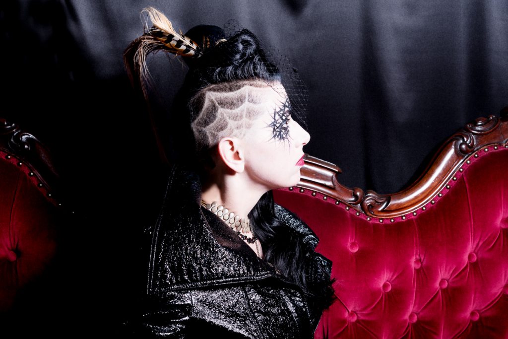 goth woman shows off spiderweb undercut in her dark hair, Halloween shaved hair designs for thin hair toppik hair blog