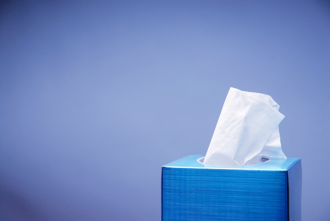 a box of tissue in front of a blue background
