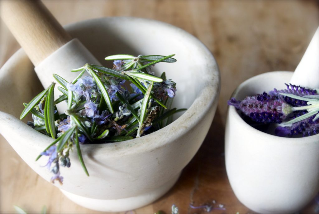 closeup fresh lavender flowers rosemary leaves in white ceramic mortar and pestle wood tabletop best DIY hair thickening mask toppik hair blog