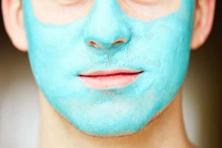 man with a blue facial mask