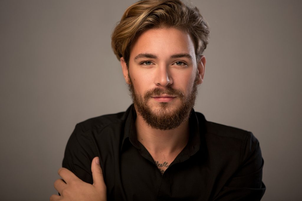 closeup handsome man beard blonde voluminous shag haircut shag haircuts for men and women toppik hair blog