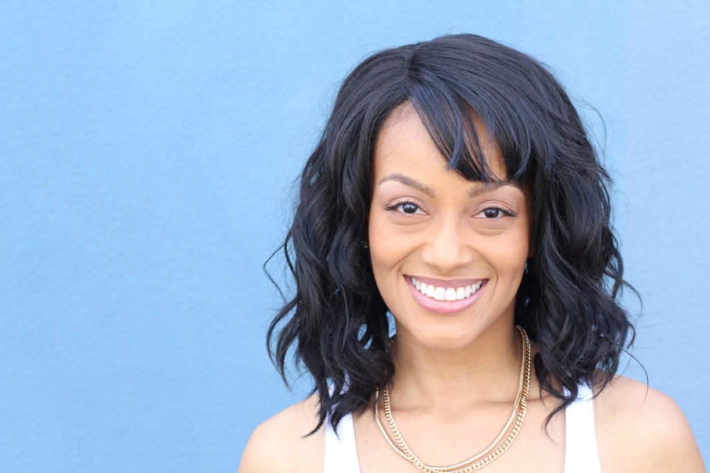 black hair african american woman smiling side swept bangs heart shape face hairstyles ace shape