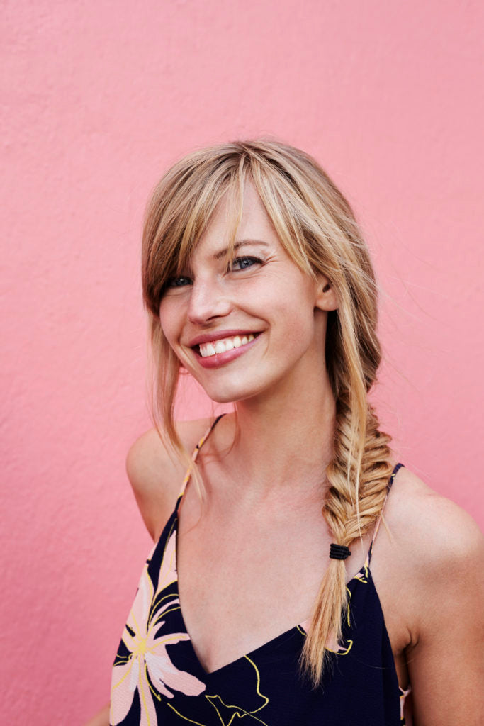 fishtail-braid-long-hair-blonde-woman-smiling-best-gym-hairstyles-toppik-blog