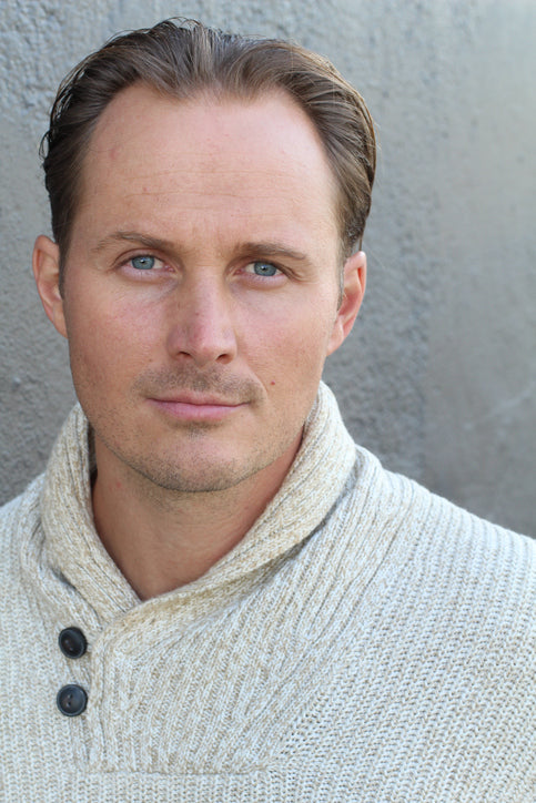 Man with longer hair in the front falling to the sides to help hide hairline recession.