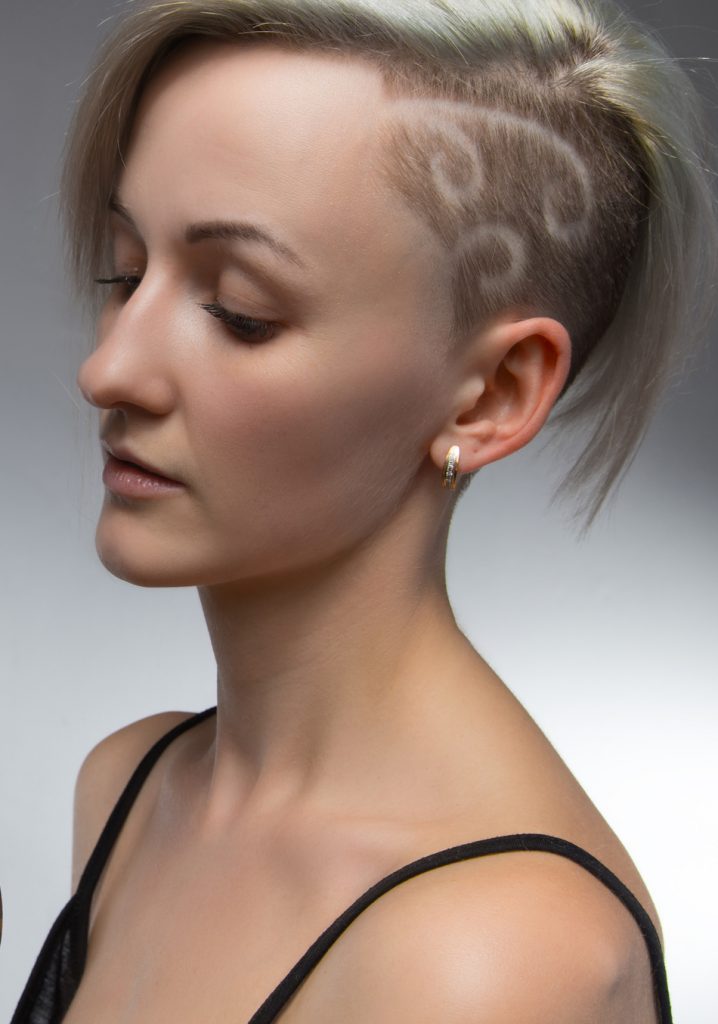 blonde woman shows her Shaved Hair Swirls