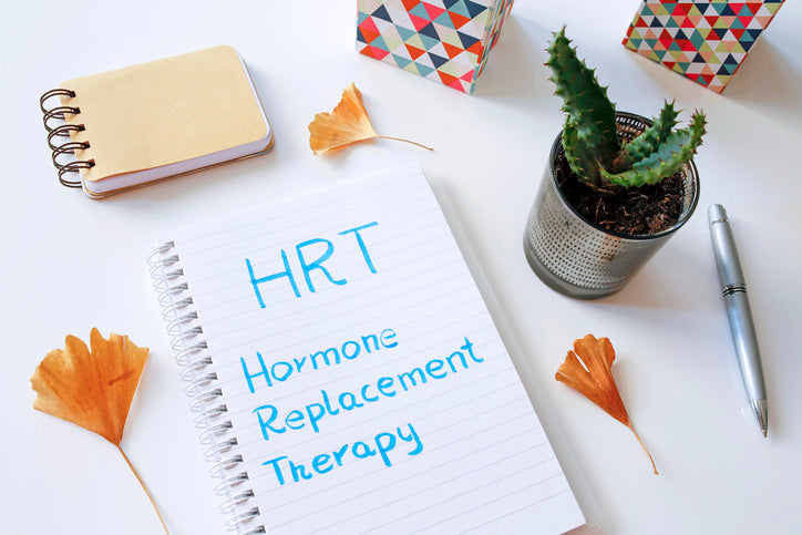 a notebook with a written text: HRT hormone replacement therapy