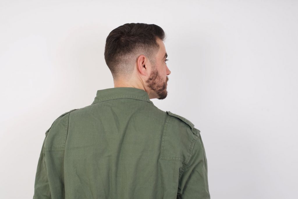 back view of a man with a beard and fade haircut