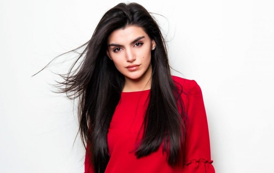 woman long black hair side part red shirt white background haircuts for thin long hair toppik hair blog