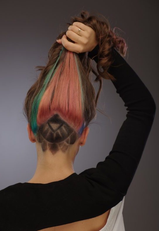 Woman showcases her Geometric shaved hair design with Color