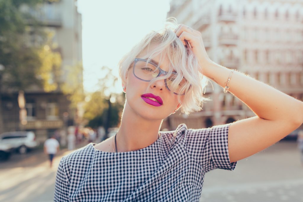 Woman with a French bob haircut styled to flatter a round face.