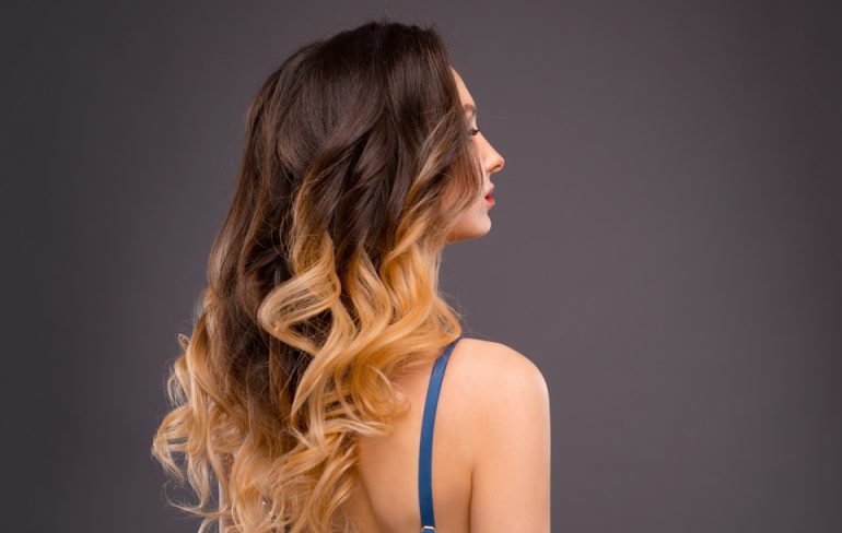 woman with ombre highlights in her long wavy hair - What is sombre hair?
