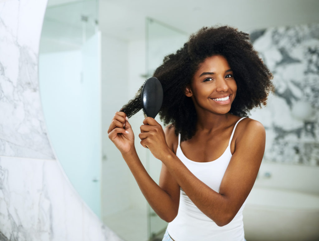 brush-curly-hair-mirror-african-american-woman-growth-tips-hair-care-routine