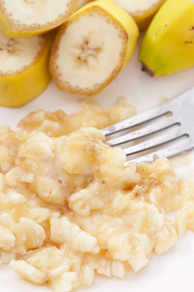 closeup mashed banana fork sliced bananas white background best DIY hair thickening mask toppik hair blog