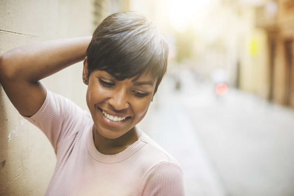 black woman smiling short pixie cut long bangs best short haircuts for women toppik hair blog