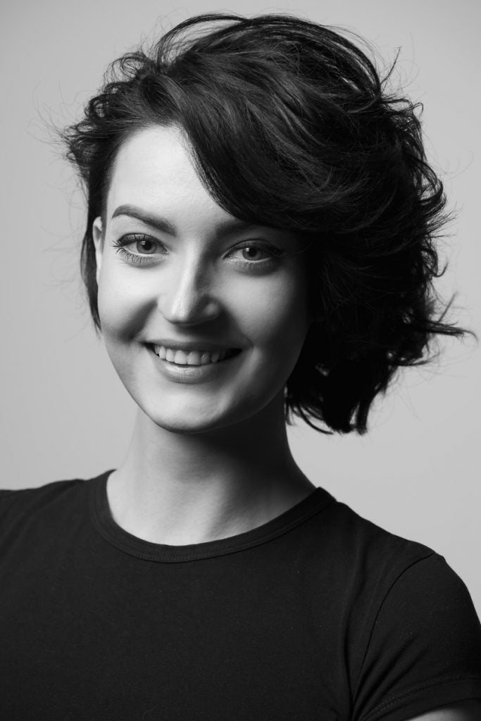 black white photo smiling woman angled bob deep side part our favorite wavy hairstyles toppik hair blog