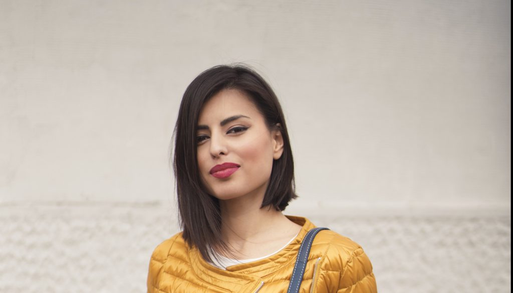 woman dark hair yellow jacket angled blunt lob best short haircuts for women toppik hair blog
