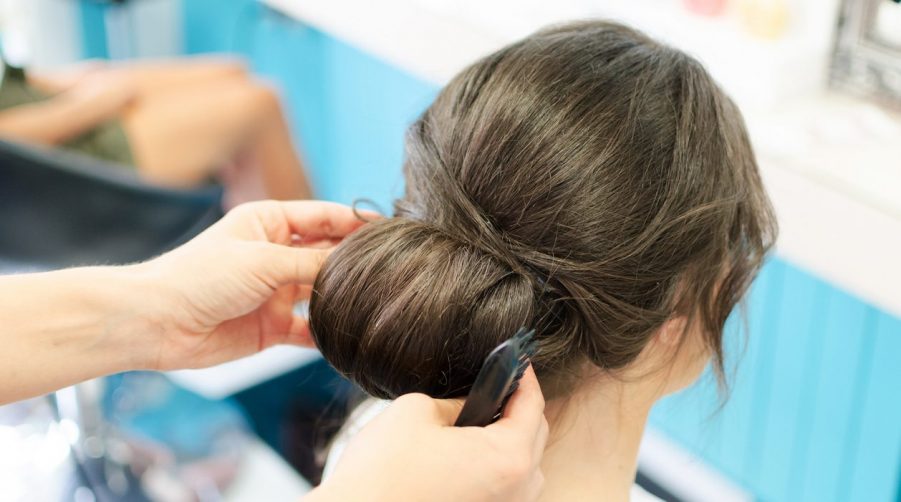 low messy bun brunette salon our favorite bun hairstyles toppik hair blog