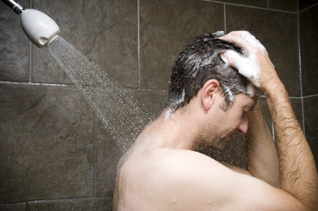 man shower side washing hair shampoo using toppik hair fibers to fix a receding hairline toppik hair blog