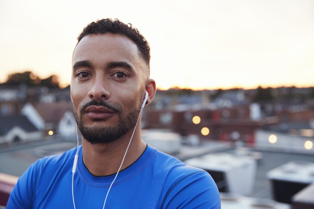 male runner african american blue shirt earphones city short haircut mens grooming tips for thin hair toppik hair blog