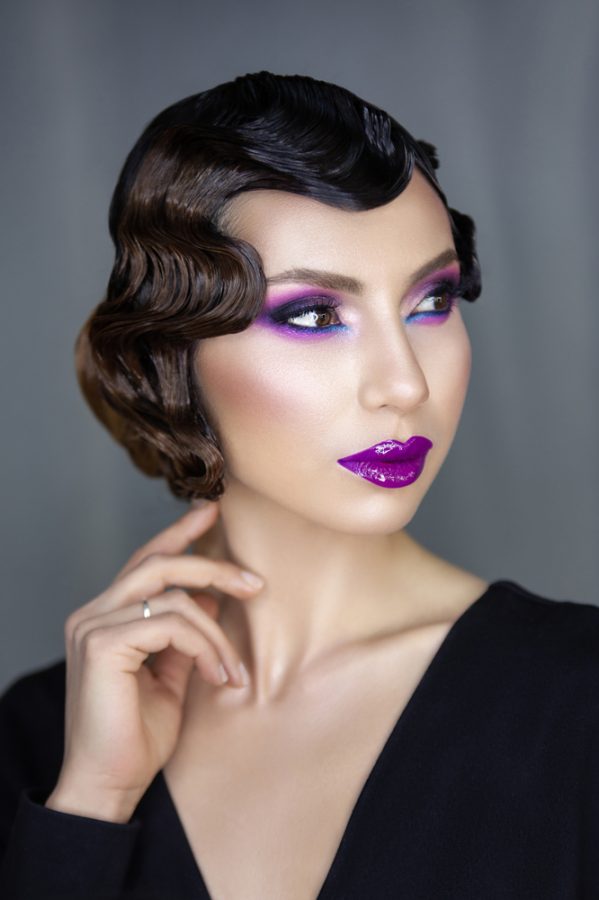 glamorous woman vintage 1920s marcel finger waves bob hairstyle purple lipstick dramatic purple pink eyeshadow makeup prepare for 2020 with 1920s hairstyles toppik hair blog
