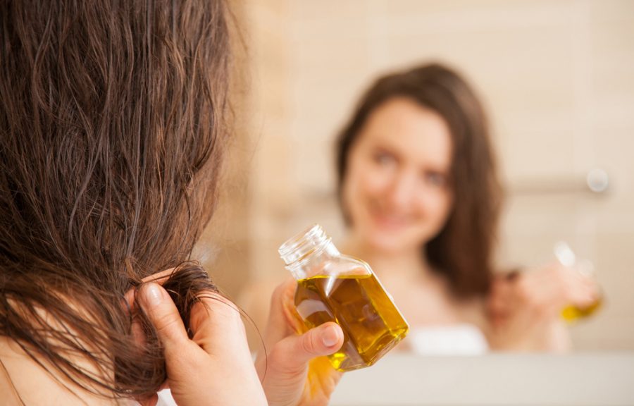 woman holding oil wet hair bathroom mirror does pumpkin oil work for hair growth? toppik hair blog