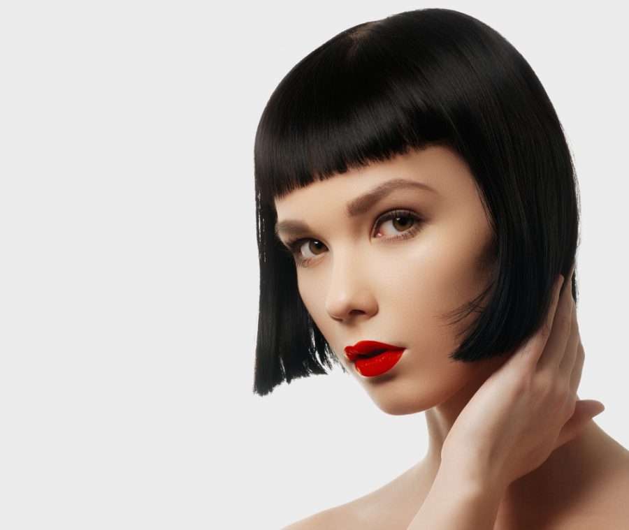 glamorous woman blunt bob flapper hairstyle bangs black hair red lipstick prepare for 2020 with 1920s hairstyles toppik hair blog