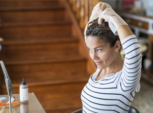 woman dyeing her hair the best root touchup spray toppik hair blog