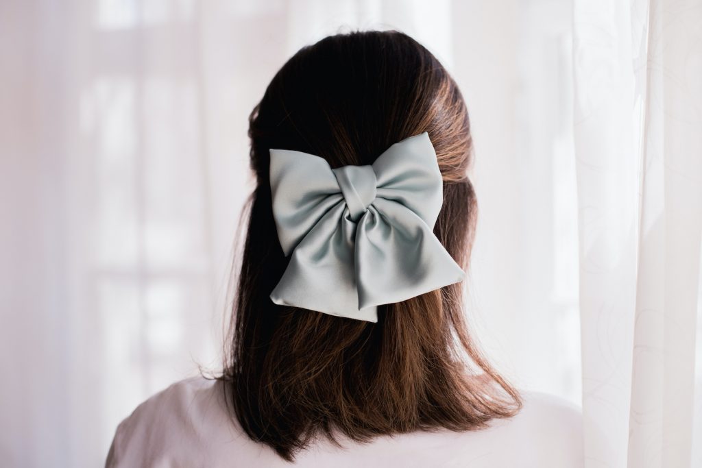 Holiday hair wrapped up with a bow! Velvet ribbon, short hair, curls, bows,  hair pretties | Bow hairstyle, Ribbon hairstyle, Short hair styles